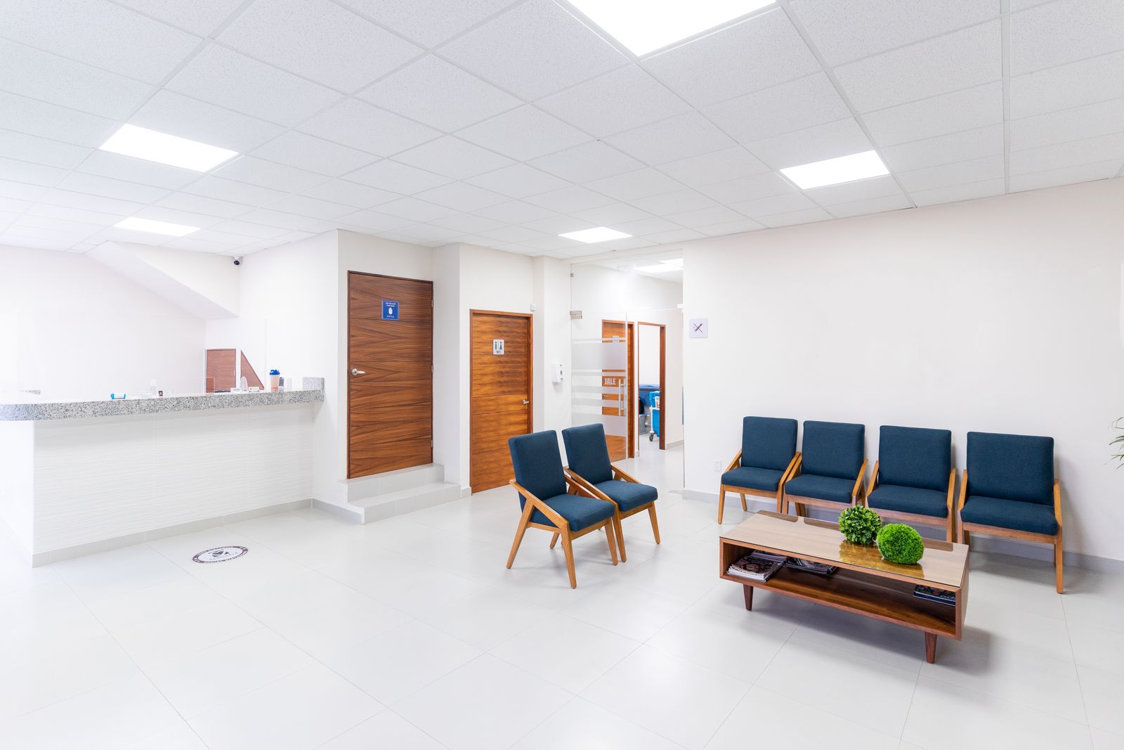 Bright, modern OPD waiting room with patient seating and reception desk